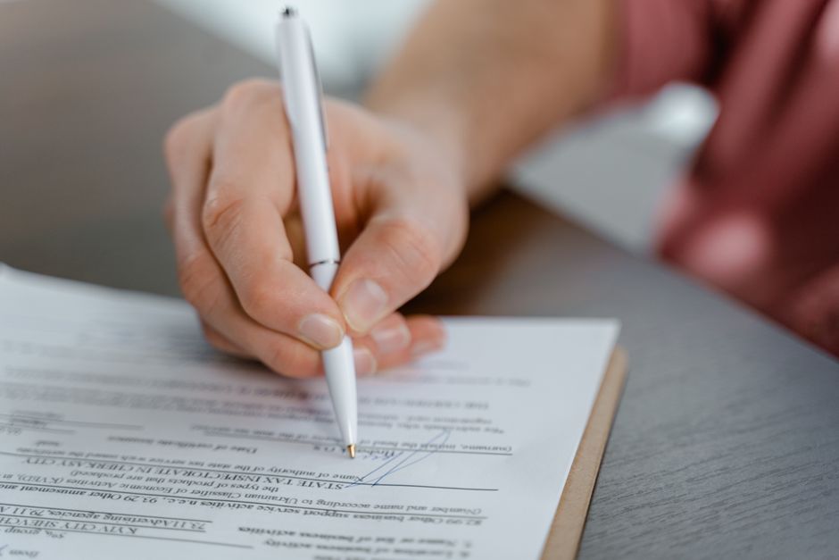 Signing paperwork close up - No deposit car rental in South Africa